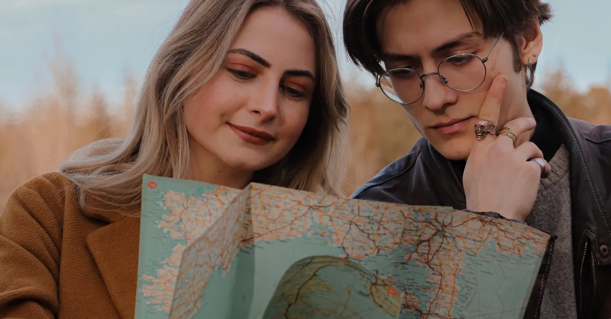 Two travellers planning a long term journey with a map