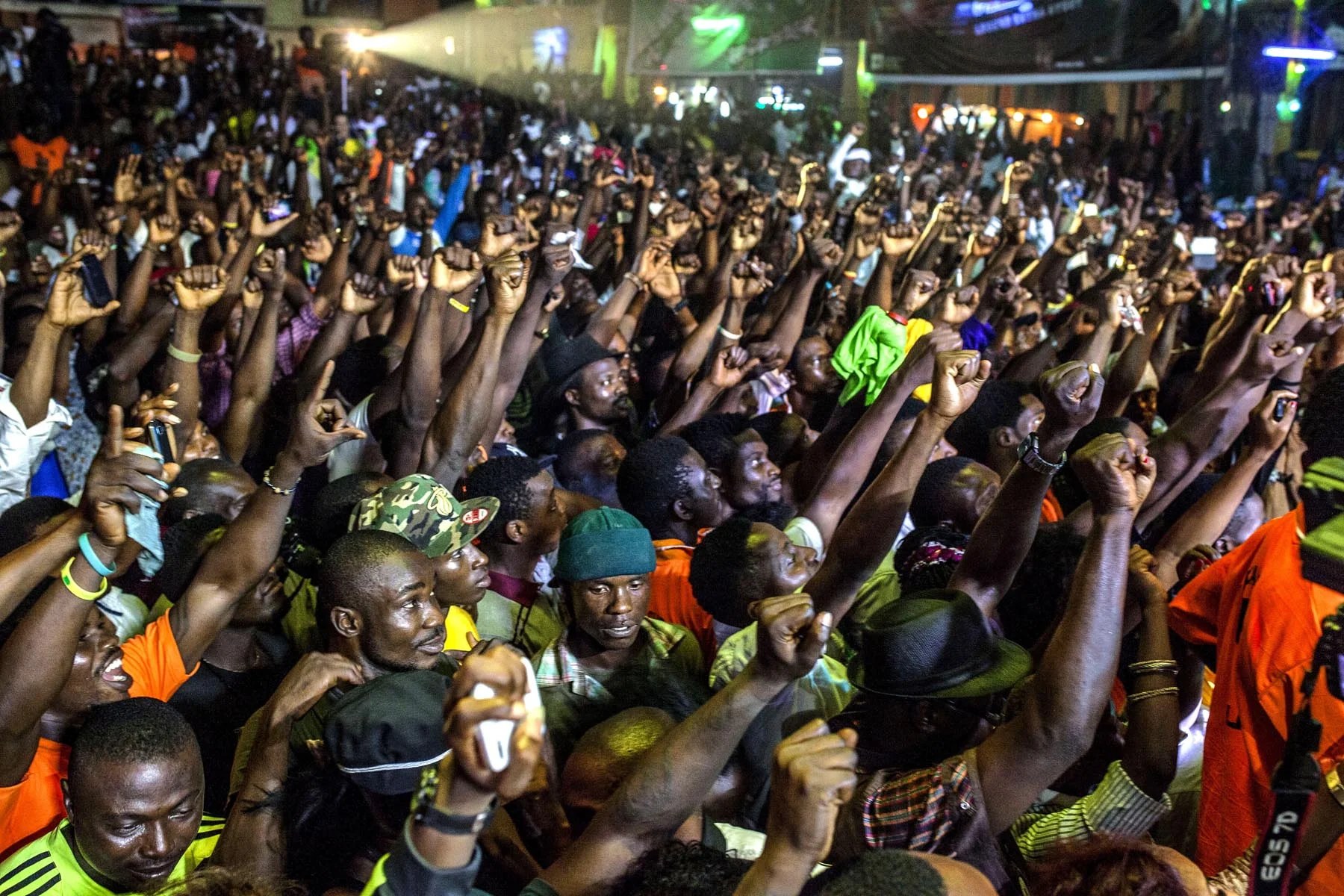 A packed Lagos concert crowd with hands raised