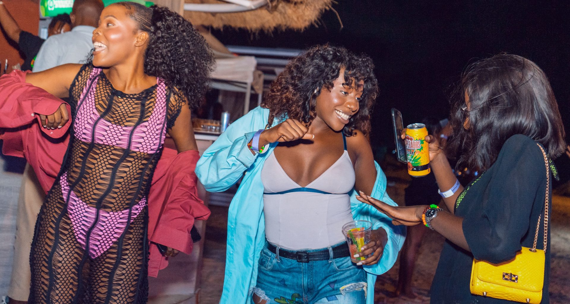 Friends dancing together at a Lagos beach party